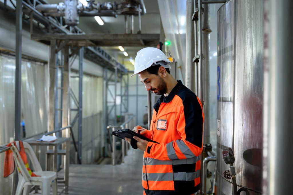 Maintenance engineer inspecting food processing pipelines.
